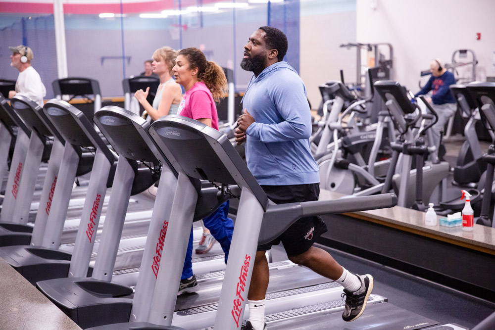 Wellness members running on treadmills.